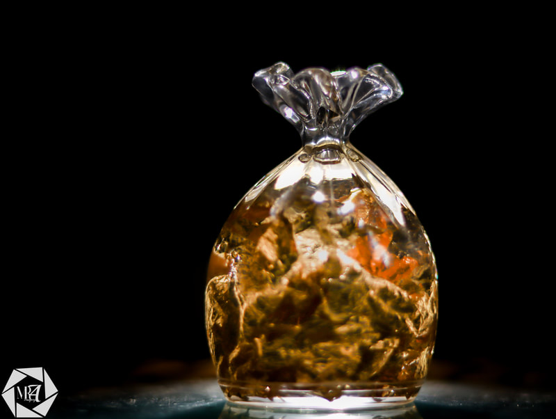 Picture of a golden glass in a dark room by Mushfiqur Rahman Abir Imagery